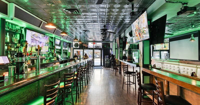 Interior, bar area, stools, tv screnns above bar, entrance door