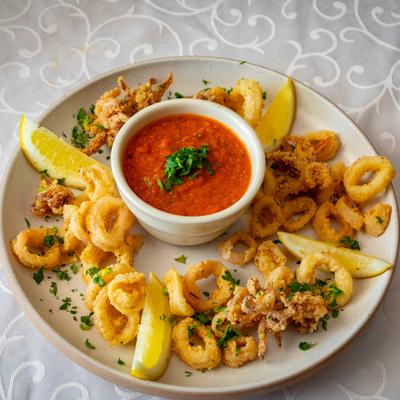 Fried calamari served with lemon wedges, fresh herbs and marinara sauce.