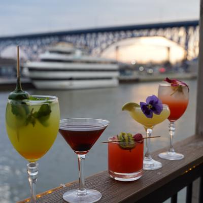 Cocktail selection served on a terrace overlooking the river.