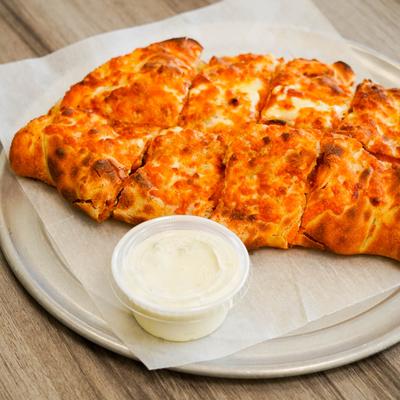 Buffalo Chicken Calzone served with a sauce.
