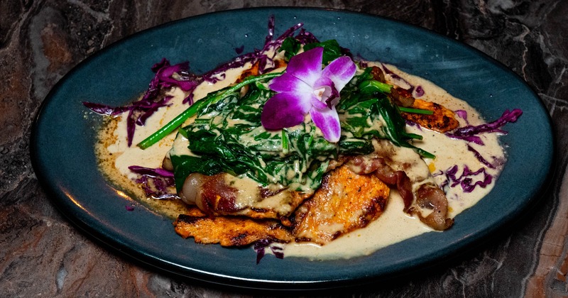 Grilled chicken topped with a cream sauce and sautéed spinach