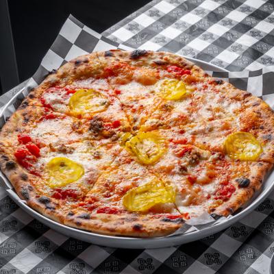 Belle's Happy Meal Pizza topped with crumbled meat and yellow banana peppers.