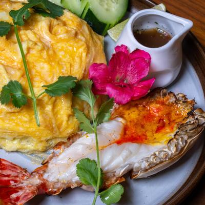 Lobster served with omelet and sauce.