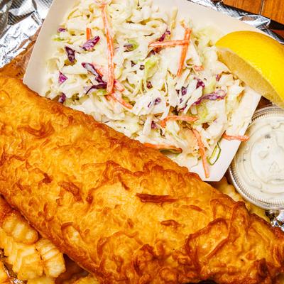 Fish fry with fries, sauce  and coleslaw.