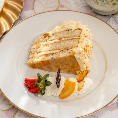 A plate with a slice of Italian cream cake on it.