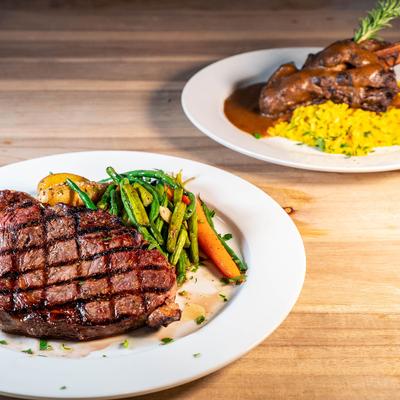 Grilled ribeye with vegetables, and braised lamb shank with saffron risotto