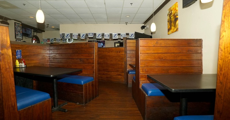 Interior, wooden seating booths with tables, wooden dividers, lanterns
