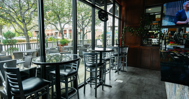 Tables placed next to large windows overlooking the restaurant