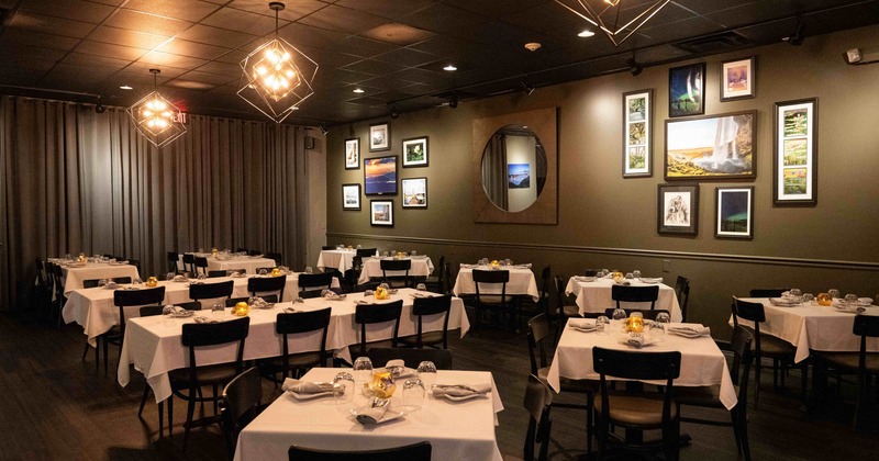 Interior seating area with chairs and tables, wall decoration