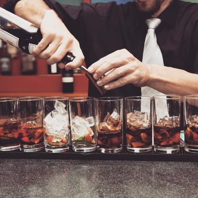 A bartender pouring drinks.