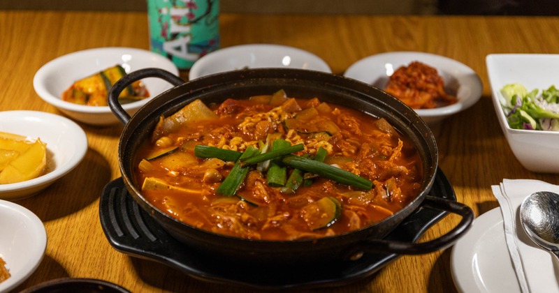 Spicy Korean army stew served in a metal pot
