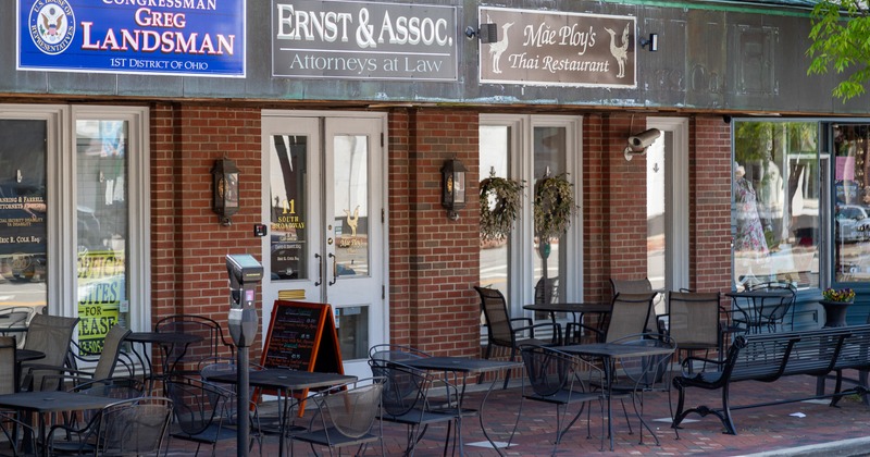 Exterior, front of restaurant, angle view, entrance, sign, chairs and tables on a porch