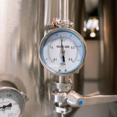 Pressure gauge attached to stainless steel brewing tank.