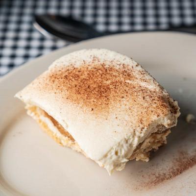 Tiramisu served on a checkered tablecloth.