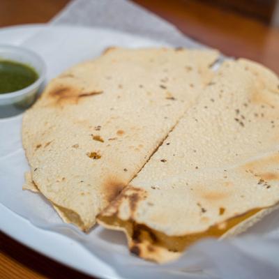 Two papads  and a side of sauce.