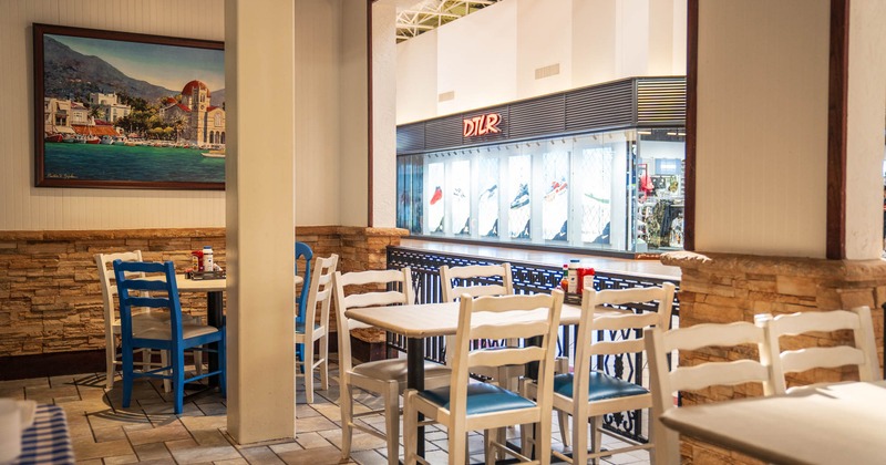 Interior, dining area, white and blue tables and chairs, stone tile flooring