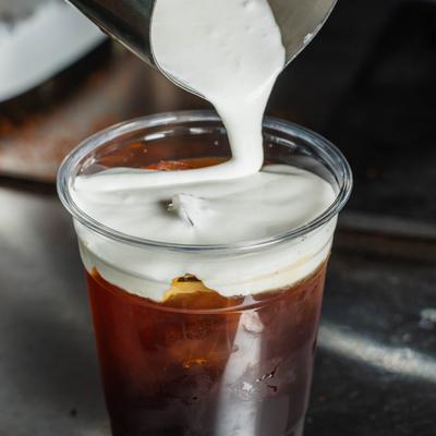 Daffodil caramel latte being poured.
