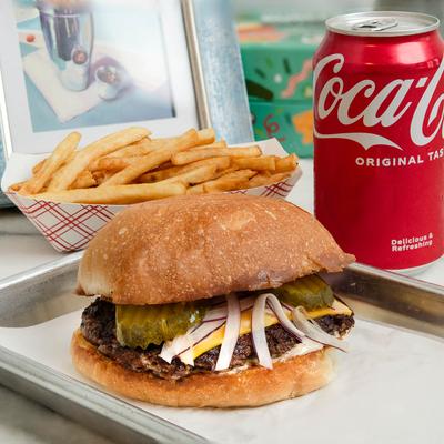 Sylvester smash burger, served with fries, a scoop of ice cream, and a canned soda.