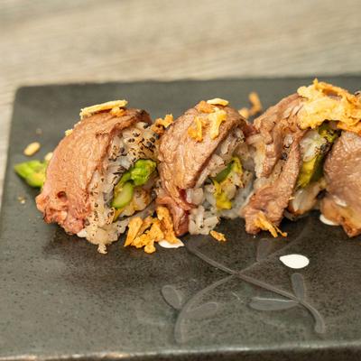 Lobster sushi rolls, with avocado, asparagus, cucumber, and topped with filet mignon.