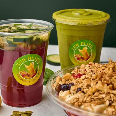 Acai Bowl served alongside a couple of drinks in a plastic cups.