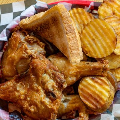 Four piece chicken with potato rounds and toast.