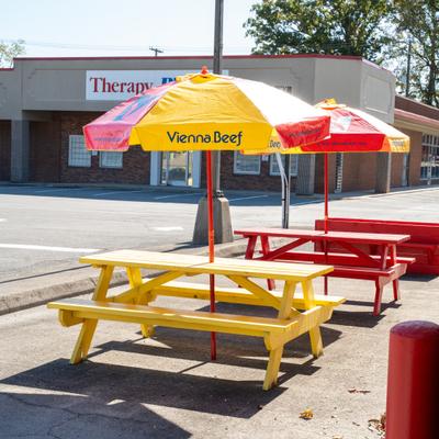 Exterior, diner area, tables, benches, parasols.