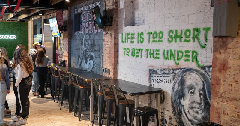 Interior, high tables and chairs near wall