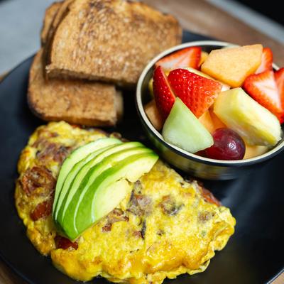 Bacon Omelet, Marinated Grape Tomatoes & Cheddar Topped with Sliced Avocado.