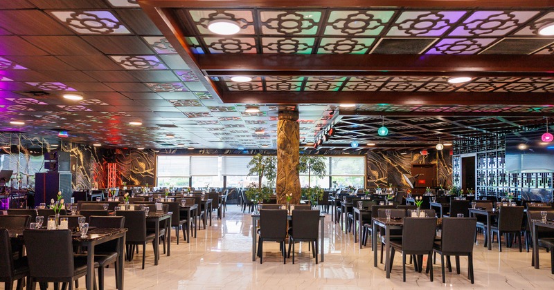Interior with patterned ceilings, black furniture, and marble-like floors