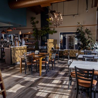 The interior space of the restaurant, tables and chairs.