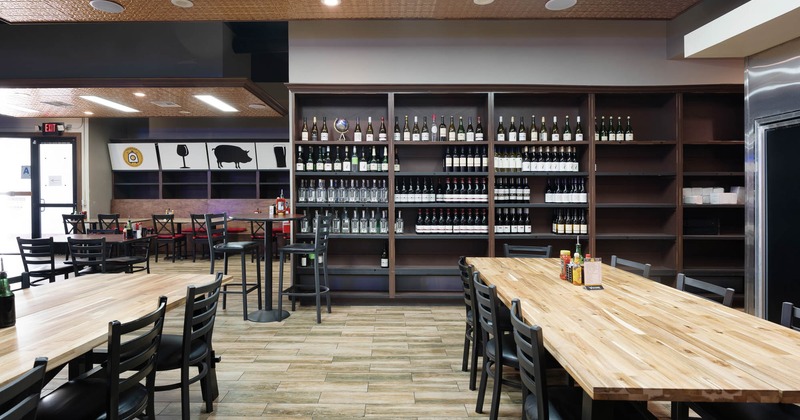 Cafe interior, tables, seats and wine shelves