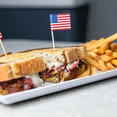 The hot pastrami sandwich with the USA flag.
