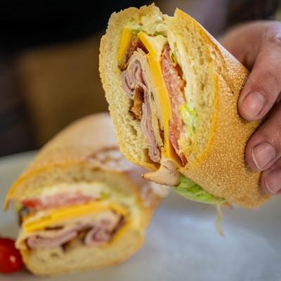 Tower Supreme Sandwich with Cajun turkey, ham, American cheese, bacon, and mayo.