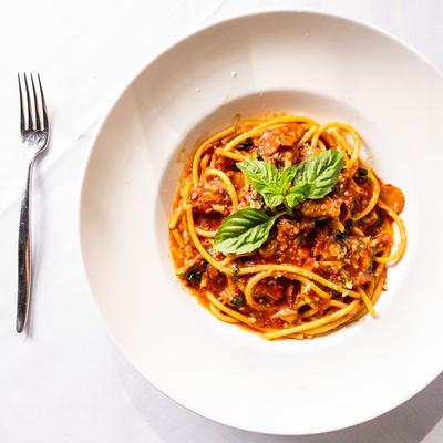 Bucatini pasta with Bolognese sauce.
