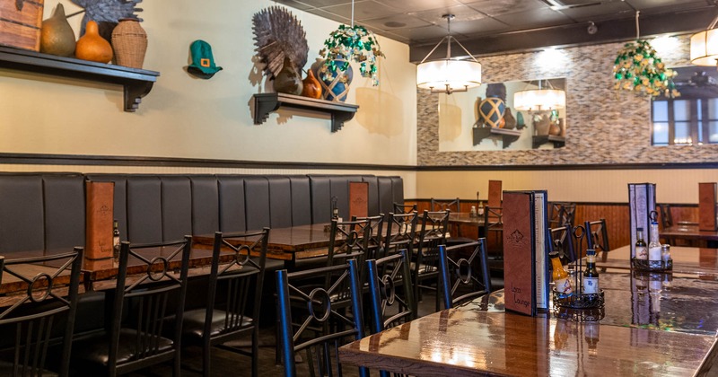 Interior, banquette seating and tables with decorative items on the wall