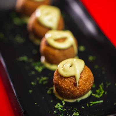 Fried cheese balls in sauce, with mustard