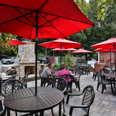 Outdoor seating area, tables with parasols.