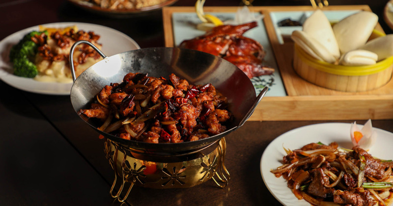 Dry Red Chili Chicken served on a table with different accompanying dishes