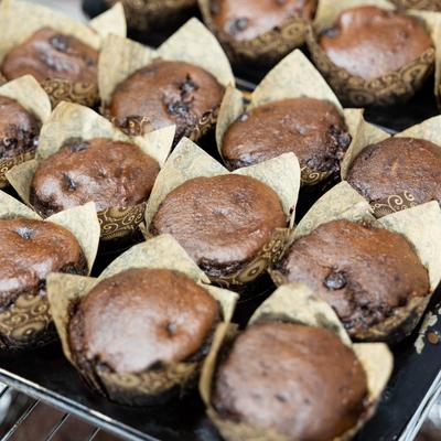Freshly baked chocolate muffins on a tray.