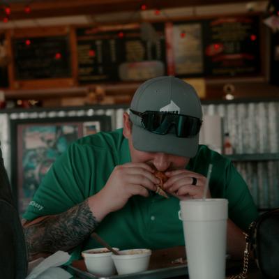 Person having food and drink at the table.