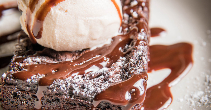 Chocolate Brownie with ice cream on top, closeup