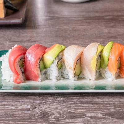 Sushi rolls topped with tuna, yellowtail, salmon, and avocado.