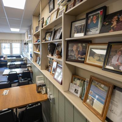 Various framed pictures on the shelf.