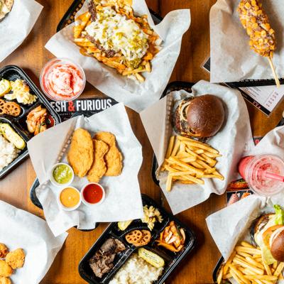 Assortment of dishes served on the table alongside drinks, overhead view.