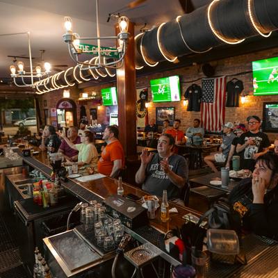 Customers watching a football game.