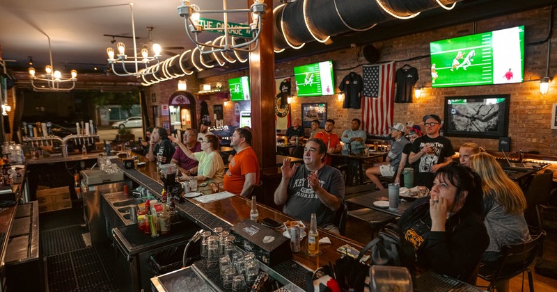 Customers watching a football game