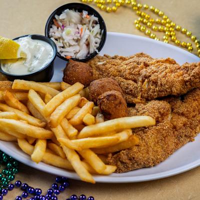 Catfish Dinner with fries, hush puppies, coleslaw, dip and lemon wedge.