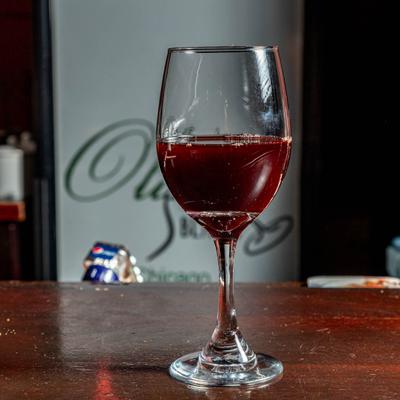 Glass of red wine, side view.