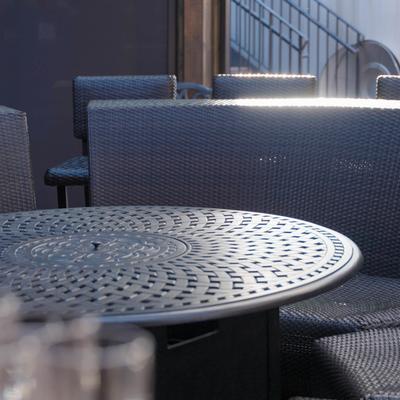 Seating area with black metal round dining table and chairs.