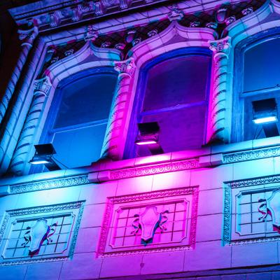 Building facade lit with colorful lights.